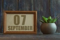 september 7th. Day 7 of month, date in frame next to succulent on wooden background autumn month, day of the year concept Royalty Free Stock Photo