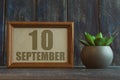 september 10th. Day 10 of month, date in frame next to succulent on wooden background autumn month, day of the year concept Royalty Free Stock Photo