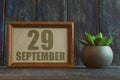 september 29th. Day 29 of month, date in frame next to succulent on wooden background autumn month, day of the year concept Royalty Free Stock Photo