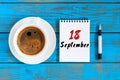 September 18th. Day 18 of month, morning cappuccino cup with loose-leaf calendar on analyst workplace background. Autumn