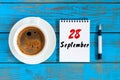 September 28th. Day 28 of month, morning coffee cup with loose-leaf calendar on financial adviser workplace background