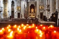 Lisbon, Portugal: burning red sacrificial candles in church