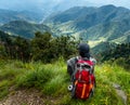 September 16th 2021 Uttarakhand INDIA. A solo hiker Hikers with a backpack looking towards the valley of Mountains. Nag Tibba trek