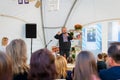 16 September 2017 Ukraine, White Church. A man with a microphone stands in front of the audience, with a view of the rear audience