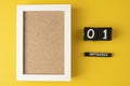 September 1 on a wooden calendar on a yellow background with empty white photo frame Royalty Free Stock Photo