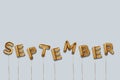 september written with foil gold balloons. september lettering with realistic gold balloons. september typography. isolated vector