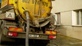 OLOMOUC, CZECH REPUBLIC, JANUARY, 20, 2021: Cesspool septic emptying pumping into pipe tank truck suction hose under Royalty Free Stock Photo