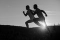 Sequence of male silhouettes running on dawn background