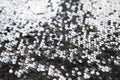 Sequin fabric texture. Shiny silver sparkling background. Clothing piece of glitter metallic for a glamorous party Royalty Free Stock Photo