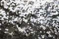 Sequin fabric texture. Shiny silver sparkling background. Clothing piece of glitter metallic for a glamorous party Royalty Free Stock Photo