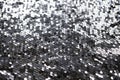 Sequin fabric texture. Shiny silver sparkling background. Clothing piece of glitter metallic for a glamorous party Royalty Free Stock Photo