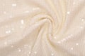 Sequinned textile has champagne colour, cream-colored textured backgrounds, drapery spangle  fabric, glamour ivory cloth, shine Royalty Free Stock Photo