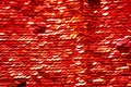Sequins close-up macro. Abstract background with red sequins. Texture scales of round sequins. Royalty Free Stock Photo