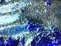 Sequins close-up macro. Abstract background with sequins colorful on the fabric. Texture scales of round sequins Royalty Free Stock Photo