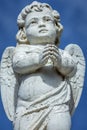 Seraphim angel praying with hands clasped for faith and hope of better days Royalty Free Stock Photo