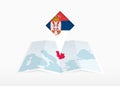 Serbia is depicted on a folded paper map and pinned location marker with flag of Serbia Royalty Free Stock Photo