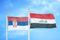Serbia and Iraq two flags on flagpoles and blue sky
