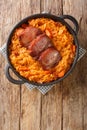 Serbian Baked Sauerkraut Podvarak with smoked pork and bacon closeup in the pan. Vertical top view Royalty Free Stock Photo