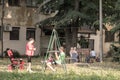 Serbian family, a mother, a father and their daughter, playing on a swing in the children playground park of Staro Sajmiste Royalty Free Stock Photo