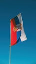 Serbian flag flapping on a pole with blue sky as background Royalty Free Stock Photo