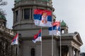 Serbian flags flutter in wind in front of National Assembly in Belgrade Royalty Free Stock Photo