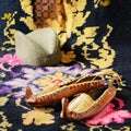 Serbian leather folk shoes opanci, kilim and traditional folk cap. Royalty Free Stock Photo