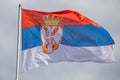 Serbian national flag on wind, outdoor Royalty Free Stock Photo