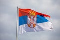 Serbian national flag on wind, outdoor Royalty Free Stock Photo