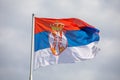 Serbian national flag on wind, outdoor Royalty Free Stock Photo