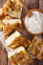 Serbian pie Gibanica with cheese, eggs and greens close-up. Vert Royalty Free Stock Photo