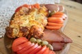 Serbian traditional food plate contain beef and pork smoked dried meet, cheese, vegetables and proja bread made of corn flour Royalty Free Stock Photo