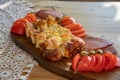 Serbian traditional food plate contain beef and pork smoked dried meet, cheese, vegetables and proja bread made of corn flour Royalty Free Stock Photo