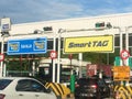 Vehicles entering highway toll canopy in Malaysia.