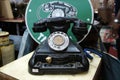 Antique pull dial round phones are on display for sale at the pawnshop.