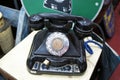 Antique pull dial round phones are on display for sale at the pawnshop.