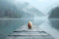 Serenade of Dawn: Easter Egg on Misty Lake Dock. Concept Travel Photography, Sunrise Serenity, Royalty Free Stock Photo