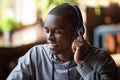 Serene african american guy wearing headphones listening favorite music Royalty Free Stock Photo