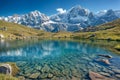 Serene Alpine Lake With Crystal Clear Waters in Front of Snow-Capped Mountains During Daytime Royalty Free Stock Photo