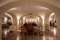 Serene Arched Crypt Interior with Worshippers and Religious Art Royalty Free Stock Photo