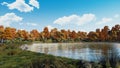 Serene autumn day on the shore of calm forest lake