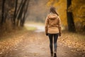 Serene autumn forest nature trail with unrecognizable woman hiking in the picturesque woods Royalty Free Stock Photo