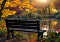 Serene Autumn Park Bench Overlooking a Pond Royalty Free Stock Photo