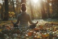 A serene autumnal yoga practice in the forest as sunlight filters through trees Royalty Free Stock Photo