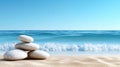 A serene beach scene with a stack of white pebbles and the ocean in the background. Royalty Free Stock Photo