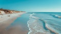 A serene beach scene, with white sandy shores and azure waters stretching to the horizon Royalty Free Stock Photo