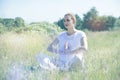 Serene beautiful yoga girl breathing and meditating crossed-legged Royalty Free Stock Photo