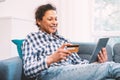 Serene black woman shopping online and electronic banking