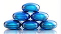Serene blue glass pebbles arranged in a pyramid shape on a reflective surface. Generative AI Royalty Free Stock Photo