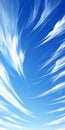 Serene blue sky background with delicate white clouds creating a dreamlike and tranquil atmosphere. Royalty Free Stock Photo