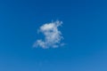 Serene blue sky with a single white cloud drifting lazily Royalty Free Stock Photo